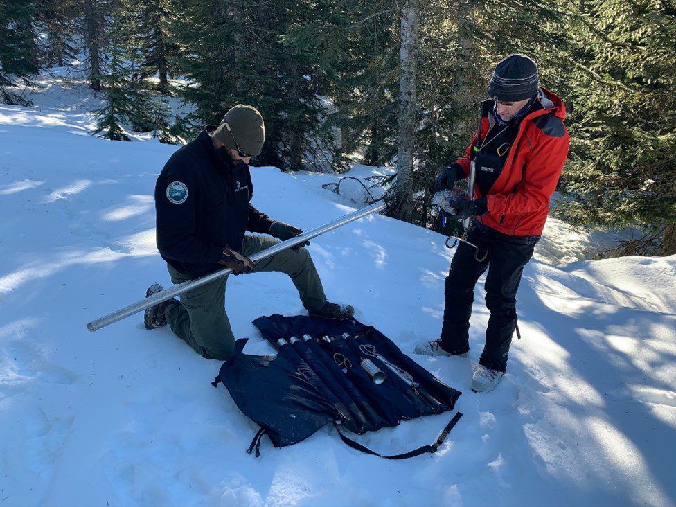 Two Watershed Protection staff conducting a snow survey.  
