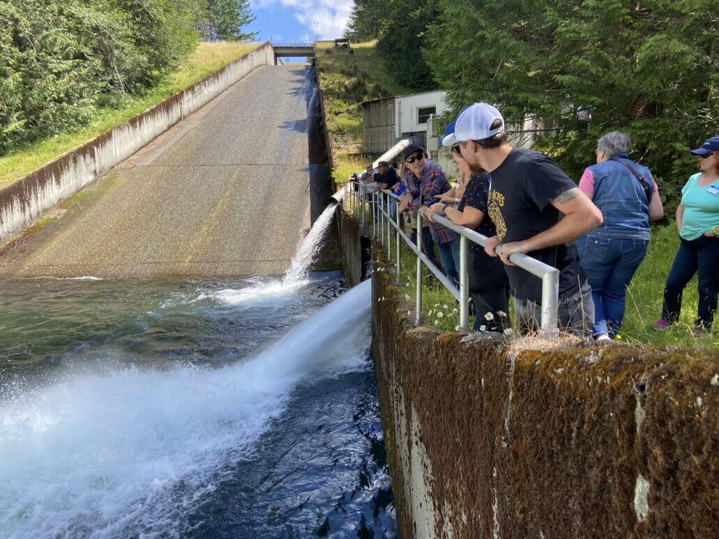 Visitors on a tour at the Tolt dam look at the spillway.