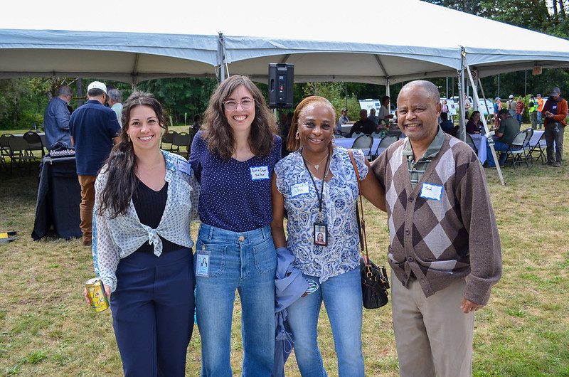 A group of four SPU employees posing for the camera at the event.