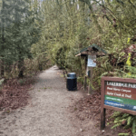 Trailhead at Lakeridge Park with signage and forest.