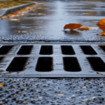A storm drain in the rain.
